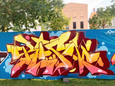 Orange and Red and Light Blue Stylewriting by Rism. This Graffiti is located in Rostock, Germany and was created in 2023.