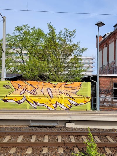 Yellow and Orange Stylewriting by Riots. This Graffiti is located in Leipzig, Germany and was created in 2023. This Graffiti can be described as Stylewriting and Line Bombing.