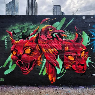 Light Green and Red Characters by REVES ONE. This Graffiti is located in London, United Kingdom and was created in 2022. This Graffiti can be described as Characters and Wall of Fame.