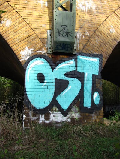 Cyan and Black Stylewriting by urine, Pizar and OST. This Graffiti is located in Leipzig, Germany and was created in 2013. This Graffiti can be described as Stylewriting and Street Bombing.