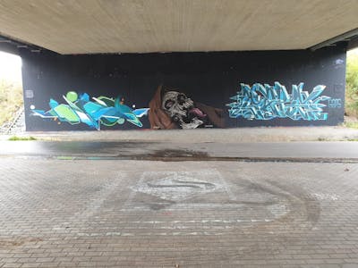 Cyan and Brown and Grey Stylewriting by Gaps, shmri and Dirt. This Graffiti is located in Leipzig, Germany and was created in 2023. This Graffiti can be described as Stylewriting, Characters and Wall of Fame.