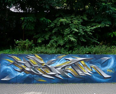 Grey and Light Blue and Beige Stylewriting by Spektrum. This Graffiti is located in Rostock, Germany and was created in 2023. This Graffiti can be described as Stylewriting and 3D.