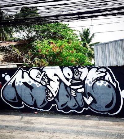 Grey and White Stylewriting by DOD crew, Hootive and TMC. This Graffiti is located in Thailand and was created in 2022. This Graffiti can be described as Stylewriting and Characters.