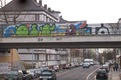 Colorful and Light Green Characters by urine, Pizar, Jolly Fellow and OST. This Graffiti is located in Leipzig, Germany and was created in 2011. This Graffiti can be described as Characters, Stylewriting, Street Bombing and Line Bombing.