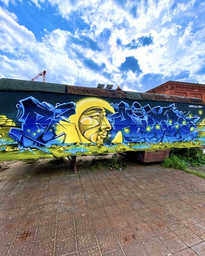Blue and Yellow Stylewriting by Raitz. This Graffiti is located in Germany and was created in 2022. This Graffiti can be described as Stylewriting, Cars and Characters.