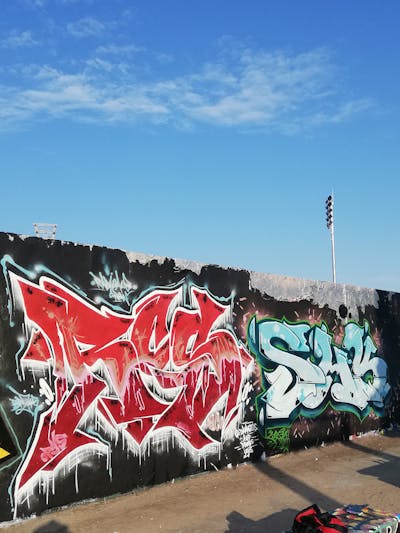 Red and Light Blue and Colorful Stylewriting by SHK and RCS. This Graffiti is located in Berlin, Germany and was created in 2023. This Graffiti can be described as Stylewriting and Wall of Fame.