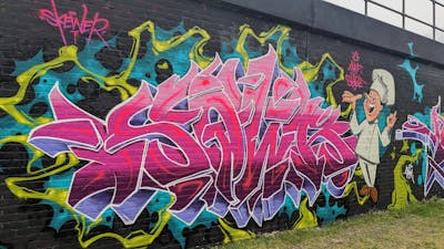 Coralle and Colorful Stylewriting by SQWR. This Graffiti is located in London, United Kingdom and was created in 2023. This Graffiti can be described as Stylewriting, Characters and Wall of Fame.