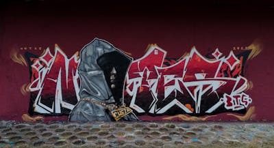 Red and Grey Stylewriting by Notes, BTS and POK. This Graffiti is located in Prague, Czech Republic and was created in 2022. This Graffiti can be described as Stylewriting, Characters and Wall of Fame.