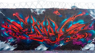 Red and Light Blue and Violet Stylewriting by SNUZ. This Graffiti is located in Paris, France and was created in 2022.