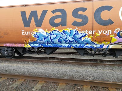 Light Blue and Blue Stylewriting by Angel, ALL CAPS COLLECTIVE and DCK. This Graffiti is located in Hungary and was created in 2019. This Graffiti can be described as Stylewriting, Trains and Freights.
