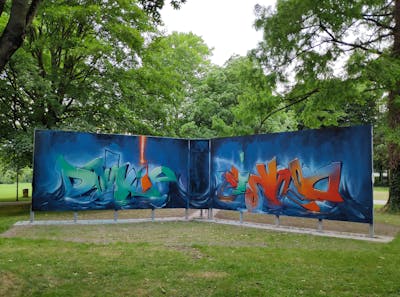Blue and Cyan and Orange Stylewriting by Dj Dookie and WKS. This Graffiti is located in Paderborn, Germany and was created in 2022. This Graffiti can be described as Stylewriting and Wall of Fame.