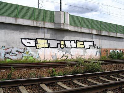 White and Yellow Stylewriting by urine, OST, KCF and Fezz. This Graffiti is located in Leipzig, Germany and was created in 2009. This Graffiti can be described as Stylewriting, Roll Up and Line Bombing.