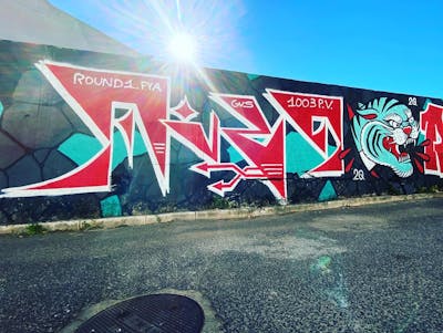Cyan and Red Stylewriting by Fire. This Graffiti is located in Lisboa, Portugal and was created in 2020. This Graffiti can be described as Stylewriting, Wall of Fame and Characters.