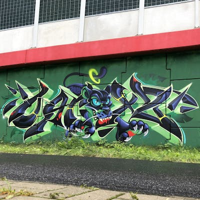Green and Black Stylewriting by Ogryz. This Graffiti is located in Poland and was created in 2021. This Graffiti can be described as Stylewriting and Characters.