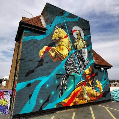 Gold and Colorful Murals by REVES ONE and SIDOK. This Graffiti is located in London, United Kingdom and was created in 2022. This Graffiti can be described as Murals and Characters.
