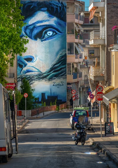 Light Blue and White Streetart by Zamkos. This Graffiti is located in Kozani, Greece and was created in 2020. This Graffiti can be described as Streetart, Murals and Characters.