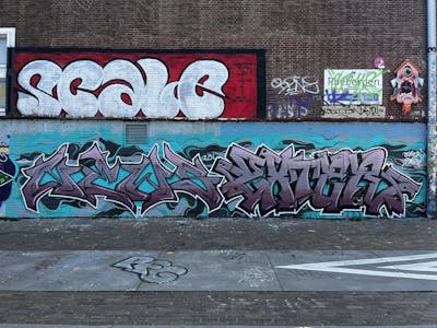 Cyan and Grey Stylewriting by Exter, News and SCALE. This Graffiti is located in Amsterdam, Netherlands and was created in 2023. This Graffiti can be described as Stylewriting and Wall of Fame.