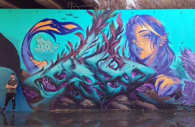 Cyan and Violet and Colorful Stylewriting by YEKO and herer. This Graffiti is located in Valencia, Spain and was created in 2024. This Graffiti can be described as Stylewriting, Characters, Streetart and Murals.