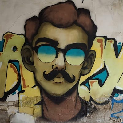 Beige and Brown and Light Blue Characters by AZY. This Graffiti is located in Baku, Azerbaijan and was created in 2019. This Graffiti can be described as Characters and Abandoned.
