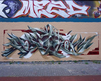 Grey and Red Stylewriting by Spektrum. This Graffiti is located in Rostock, Germany and was created in 2022. This Graffiti can be described as Stylewriting, Characters, 3D and Wall of Fame.
