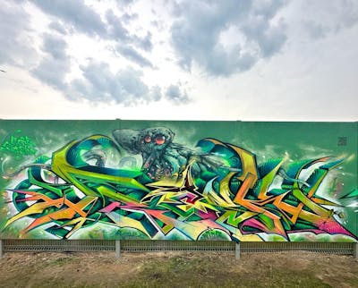 Green and Colorful Stylewriting by Core and Fresk. This Graffiti is located in lublin, Poland and was created in 2023. This Graffiti can be described as Stylewriting, Characters and Wall of Fame.