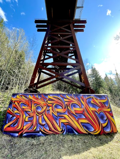 Orange and Violet Stylewriting by BLUBLA, TMC and Fresco. This Graffiti is located in Prince George, Canada and was created in 2024. This Graffiti can be described as Stylewriting and Atmosphere.