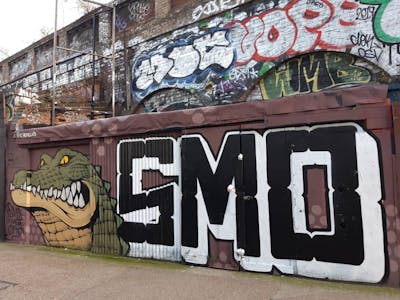 Black and White and Colorful Stylewriting by Nelius and smo__crew. This Graffiti is located in London, United Kingdom and was created in 2021. This Graffiti can be described as Stylewriting, Characters and Wall of Fame.