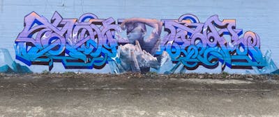 Light Blue and Violet Stylewriting by Iota and Toner2. This Graffiti is located in Brussels, Belgium and was created in 2023. This Graffiti can be described as Stylewriting and Characters.