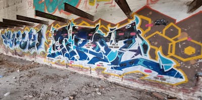 Blue and Colorful Stylewriting by M5, Tirol, Masek and 7US. This Graffiti is located in Sun city, Hungary and was created in 2023. This Graffiti can be described as Stylewriting and Abandoned.