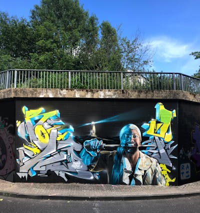 Yellow and Grey and Light Blue Stylewriting by Searok and Rowdy. This Graffiti is located in Raunheim, Germany and was created in 2019. This Graffiti can be described as Stylewriting, Characters and Murals.