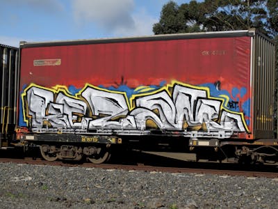 Chrome and Yellow Stylewriting by Kezam. This Graffiti is located in Auckland, New Zealand and was created in 2023. This Graffiti can be described as Stylewriting, Trains and Freights.