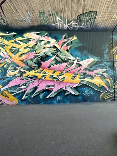 Coralle and Yellow and Cyan Stylewriting by Abik. This Graffiti is located in Ingolstadt, Germany and was created in 2023.