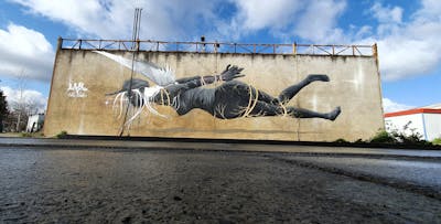 Grey and White Characters by Antistak. This Graffiti is located in Toulouse, France and was created in 2021. This Graffiti can be described as Characters and Murals.