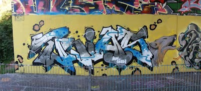 Grey and Light Blue and Beige Stylewriting by Trias. This Graffiti is located in Germany and was created in 2023. This Graffiti can be described as Stylewriting and Wall of Fame.