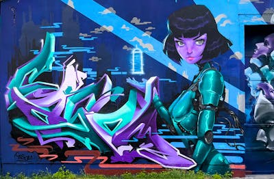 Cyan and Violet and Blue Stylewriting by casom and Emty. This Graffiti is located in Radebeul, Germany and was created in 2023. This Graffiti can be described as Stylewriting, Characters, Streetart and 3D.