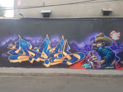 Blue and Orange and Violet Stylewriting by Doe and Humo. This Graffiti is located in Mexico city, Mexico and was created in 2023. This Graffiti can be described as Stylewriting and Characters.