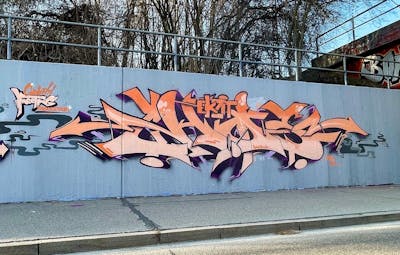 Orange Stylewriting by Eksid. This Graffiti is located in Ingolstadt, Germany and was created in 2022. This Graffiti can be described as Stylewriting and Wall of Fame.