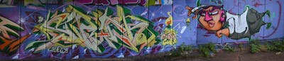 Yellow and Green and Violet Stylewriting by Fidget and Chips. This Graffiti is located in London, United Kingdom and was created in 2021. This Graffiti can be described as Stylewriting, Characters and Wall of Fame.