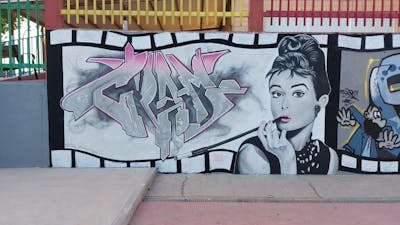 Grey and Coralle Stylewriting by Cram. This Graffiti is located in Mondéjar, Spain and was created in 2022. This Graffiti can be described as Stylewriting, Characters and Wall of Fame.