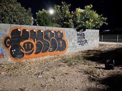 Orange and Black Stylewriting by KNEB. This Graffiti is located in Cyprus and was created in 2022. This Graffiti can be described as Stylewriting, Street Bombing and Throw Up.