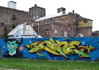 Light Green and Blue Stylewriting by Suzie and Coke. This Graffiti is located in Budapest, Hungary and was created in 2019. This Graffiti can be described as Stylewriting, Characters and Wall of Fame.