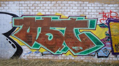 Green and Brown Stylewriting by urine, OST and kafor. This Graffiti is located in Bitterfeld, Germany and was created in 2010.