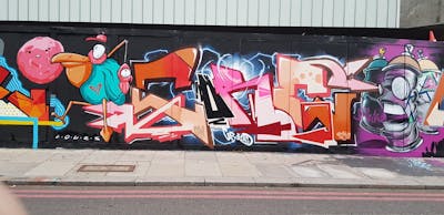 Colorful Stylewriting by Core246, Lours, smo__crew and M.Walkman. This Graffiti is located in London, United Kingdom and was created in 2020. This Graffiti can be described as Stylewriting, Characters and Wall of Fame.