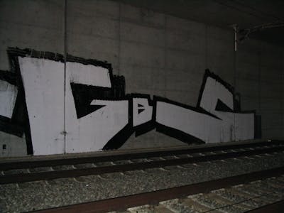 White and Black Stylewriting by urine and GBS. This Graffiti is located in Bitterfeld, Germany and was created in 2006. This Graffiti can be described as Stylewriting, Roll Up and Line Bombing.