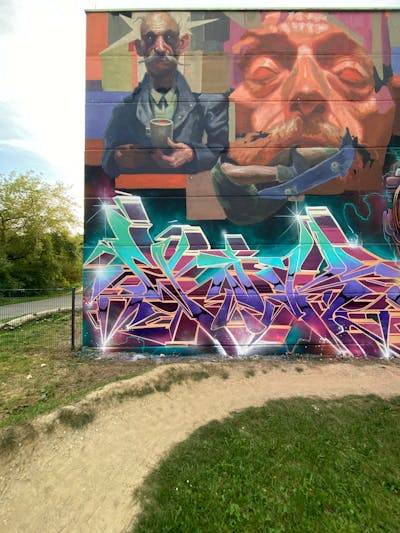 Cyan and Orange and Violet Murals by Graff.Funk, Wok, Nexgraff and nex. This Graffiti is located in Leipzig, Germany and was created in 2023. This Graffiti can be described as Murals, Stylewriting and Characters.
