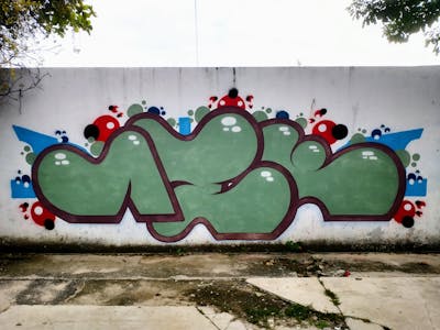 Green and Brown Street Bombing by Aek. This Graffiti is located in Acapulco, Mexico and was created in 2022. This Graffiti can be described as Street Bombing and Stylewriting.