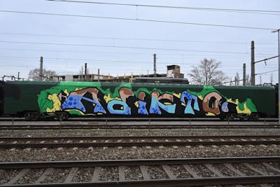 Colorful Wholecars by ADIKTO. This Graffiti is located in Vienna, Austria and was created in 2021. This Graffiti can be described as Wholecars and Stylewriting.