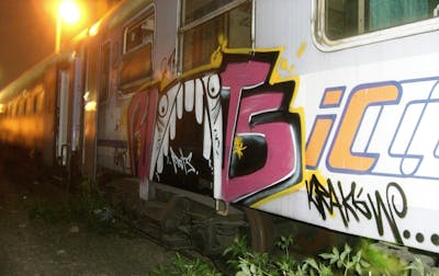 White and Coralle Trains by Riots. This Graffiti is located in Krakow, Poland and was created in 2009. This Graffiti can be described as Trains and Stylewriting.