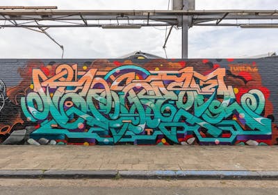 Orange and Cyan Stylewriting by OTZ and Toner2. This Graffiti is located in Belgium and was created in 2022. This Graffiti can be described as Stylewriting and Wall of Fame.