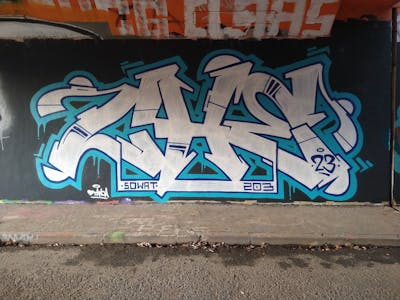 Black and Light Blue and White Stylewriting by CHE, SW and 203. This Graffiti is located in Heerlen, Netherlands and was created in 2023. This Graffiti can be described as Stylewriting and Wall of Fame.